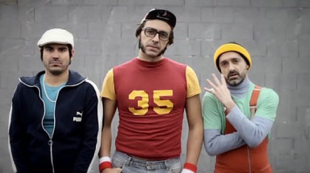 Three middle-aged men, dressed in tracksuits, vests and headbands